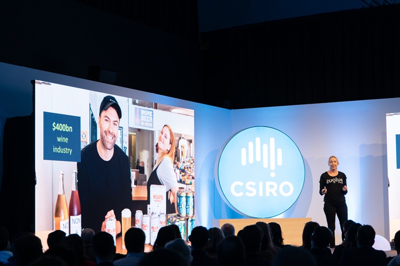 Person standing in front of large screen presenting