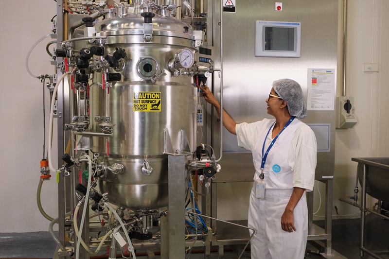 Woman in front of tank in lab