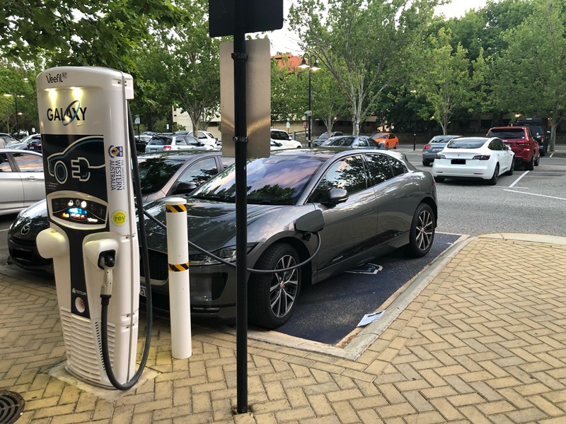 Photo of an electric car charging in a carpark. 