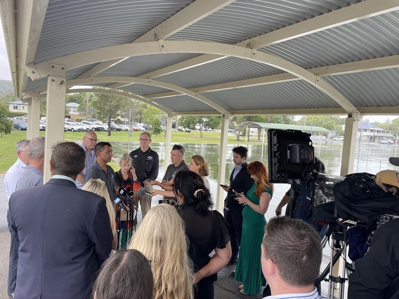 Dr Jai Vaze speaks to the media in Lismore, February 2023 about CSIRO’s work in the region.  Media is gathered around Jai taking notes and filming him.