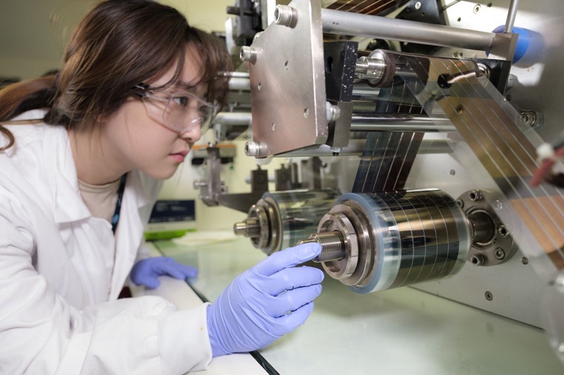 A CSIRO researcher studying a flexible solar panel