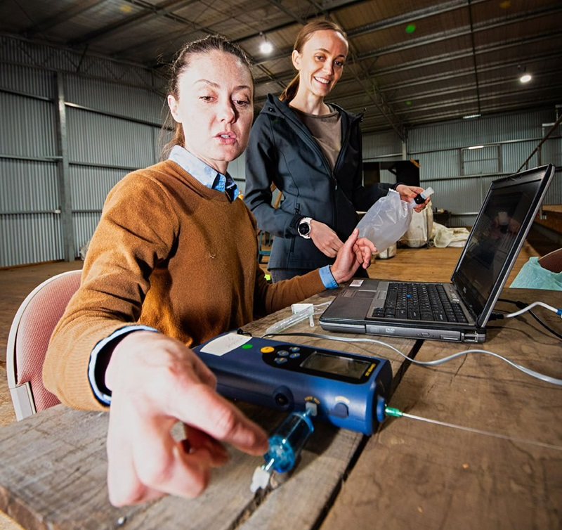 Two women using scientific devices