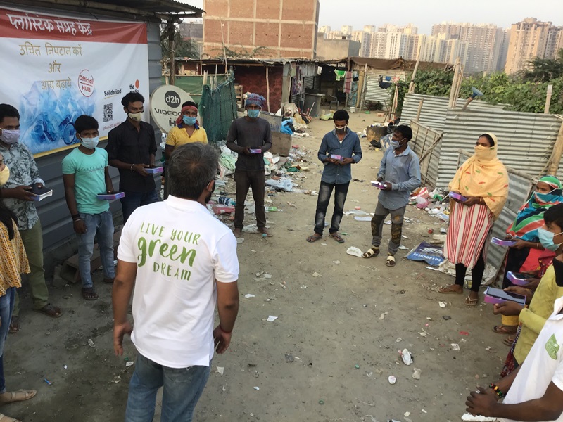 People undertaking tablet training for the Plastic Collective in India.
