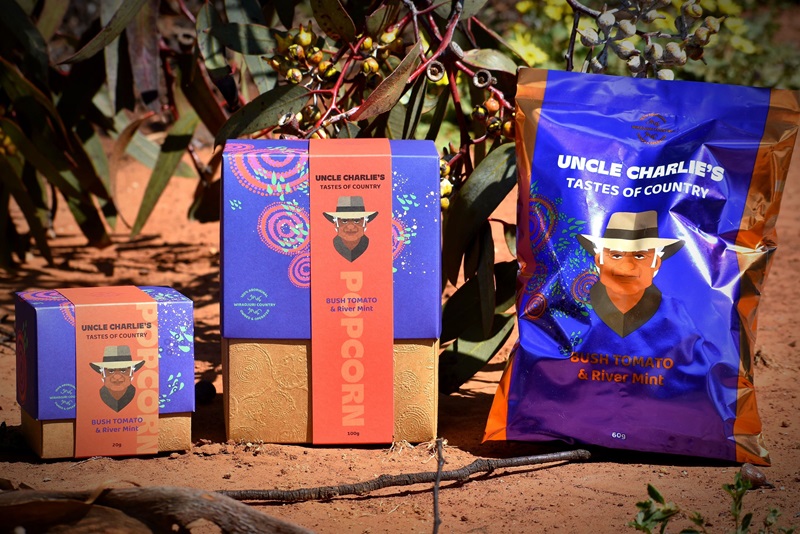 Three types of flavoured popcorn made by Uncle Charlie's Taste of Country, in an outback setting