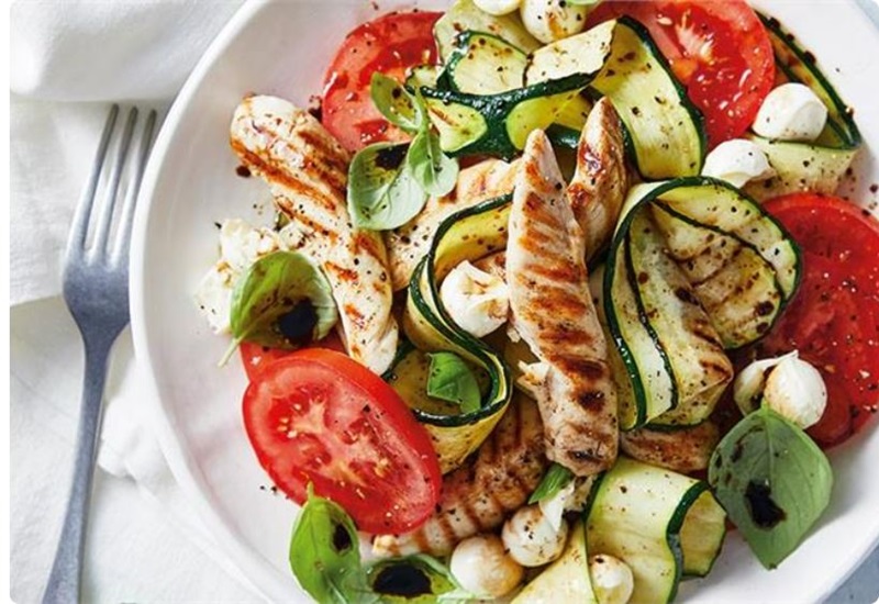 A salad of chicken and vegetables with cucumber and tomato