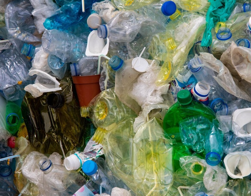 Multi-coloured single use plastics in a pile from a birds-eye-view. 