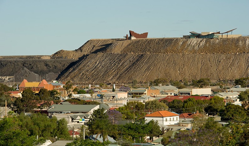 a panoramic image of a mullock heap with two buildings on top, overlooking the town of Broken Hill
