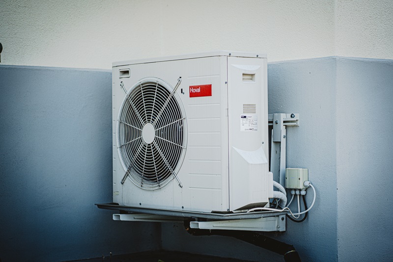 An air conditioning unit is mounted on a wall. 