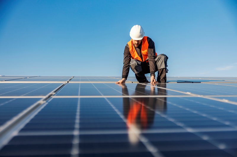 man laying solar panels