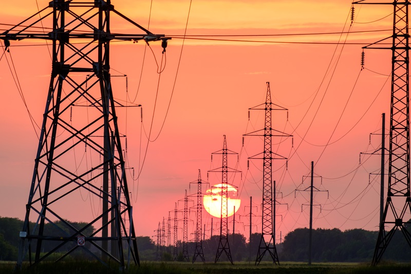 Power grids against a setting sun. 