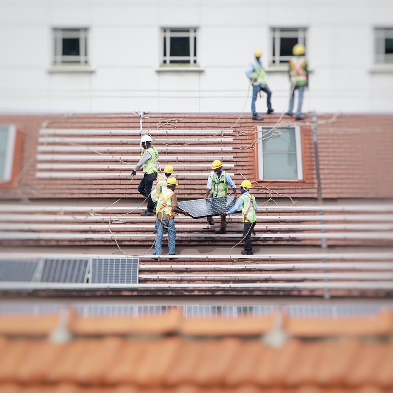 Workers installing a rooftop solar system.