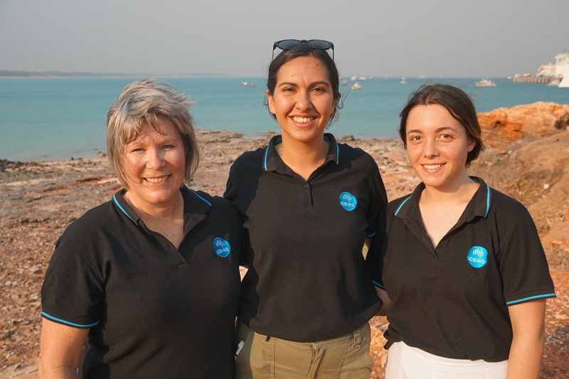 Janet Anstee stands on the left besides two other researchers, all in CSIRO uniforms.