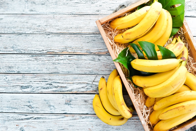 Fresh bananas in a wooden box. Top view.