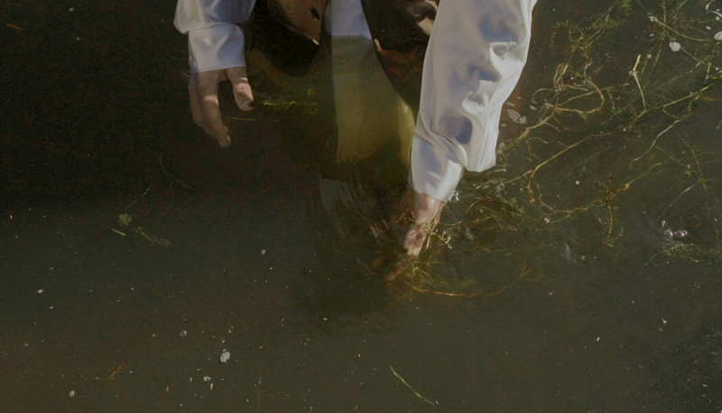 Man in White Shirt Walking in Water 
