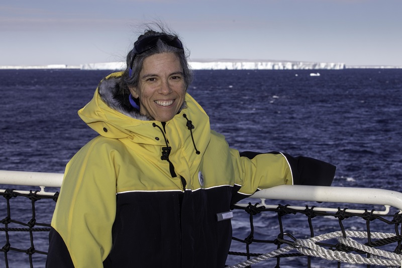 Dr Laura Herraiz Borreguero on board the RSV Nuyina with the Denman Glacier and the ocean in the background