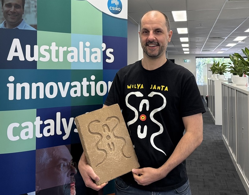 CSIRO’s Anthony Wright holds a mud brick tile from the Wilya Janta project at his office in Melbourne.
