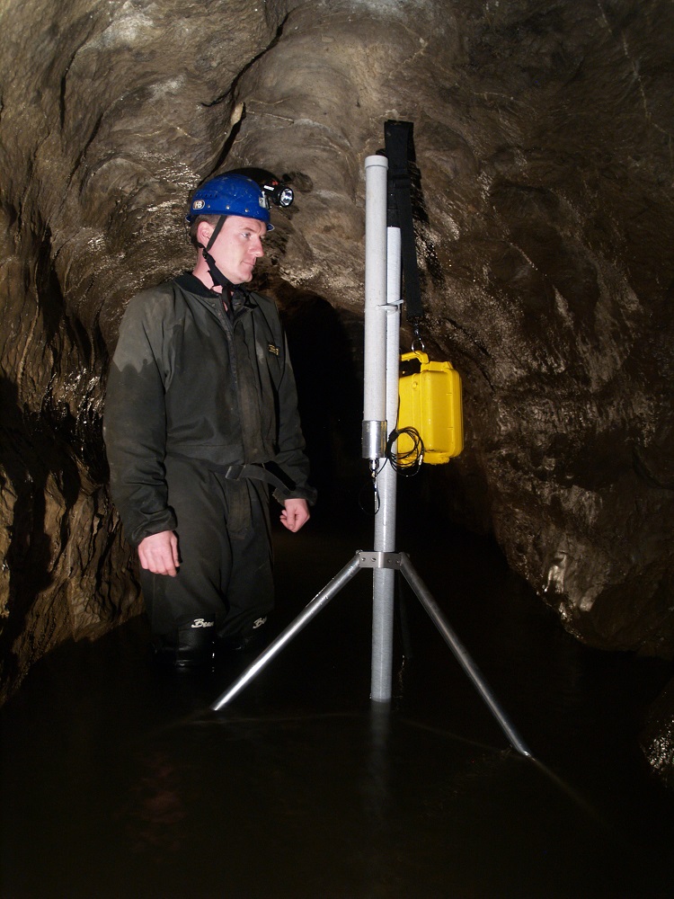 Man wearing pit helmet in cave