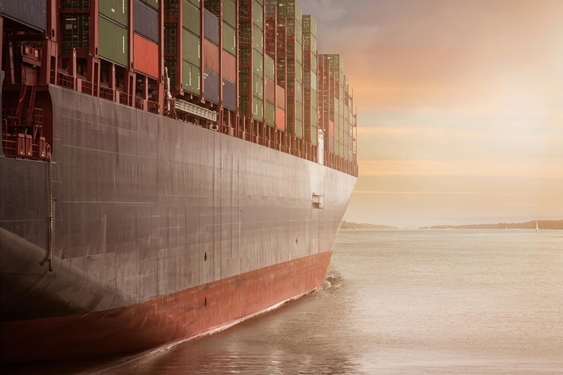 Shipping container, taken from the side looking towards a sunset