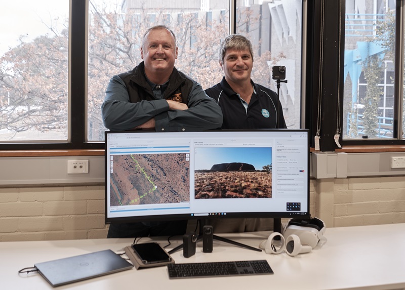 Nunzio and Bob standing behind a monitor showing images from Pannotator