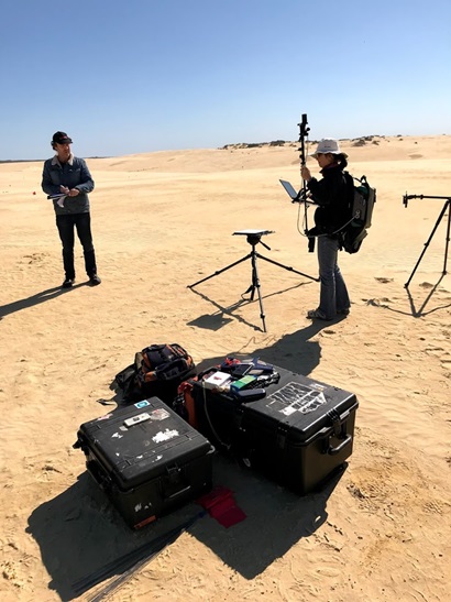 People in desert with scientific intruments