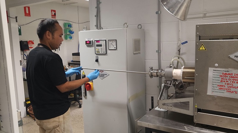 Man in lab with furnace equipment