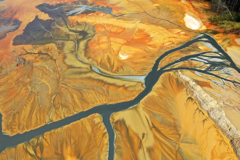 Aerial view of colorful contaminated cyanide residuals waters from gold mine.