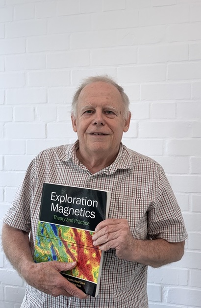 Dr Clive Foss holding book