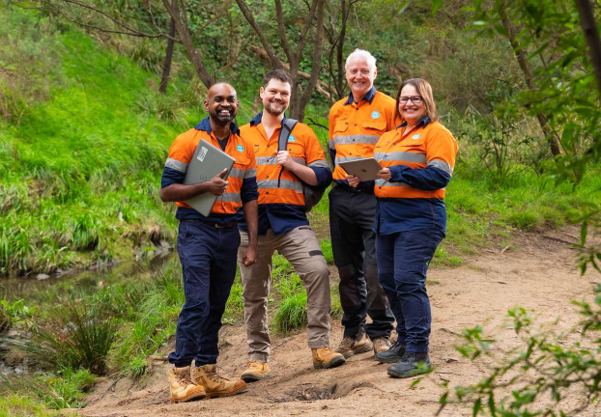 The Vesi&trade; Field Innovation and Environmental Monitoring Team in an outdoor environment - (L to R)- Dr Krishnan Murugappan, Dr David Macedo, Mr Tony Kilpatrick and Ms Daniella Caruso, all in high viz tops and work trousers.