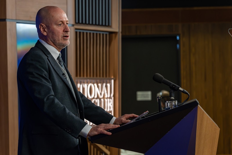 Dr Doug Hilton at a lectern speaking