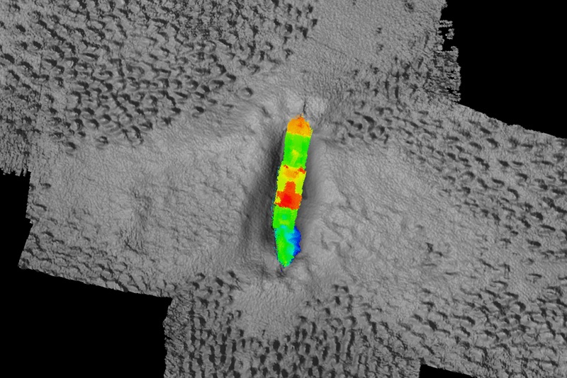 A colourful map showing a shipwreck sitting on the seafloor with colour representing different depths of water.