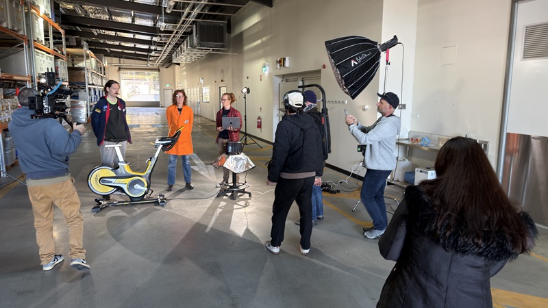 Behind the scenes of filming with camera crew and lighting