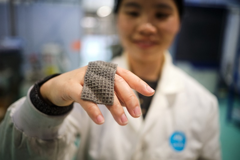 A scientist holding a piece of chainmail
