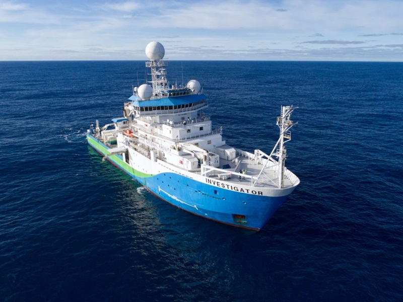 Large white boat with blue and green colouring along the sides. Boat has Investigator written in capitals on the side. 