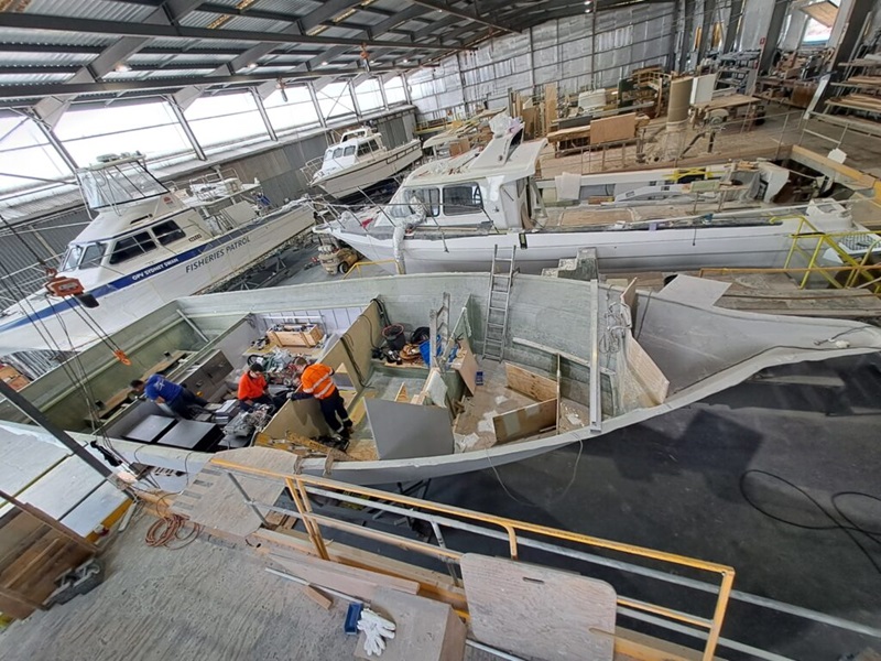 Inside a warehouse full of half-build boats.