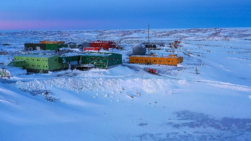 Buildings surrounded by snow and ice. 
