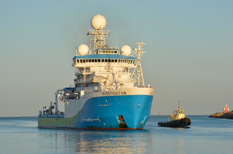 A large research vessel pulls into harbour. 