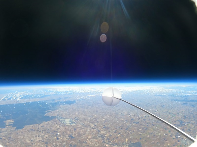 A white circle seen in space with the earth below.
