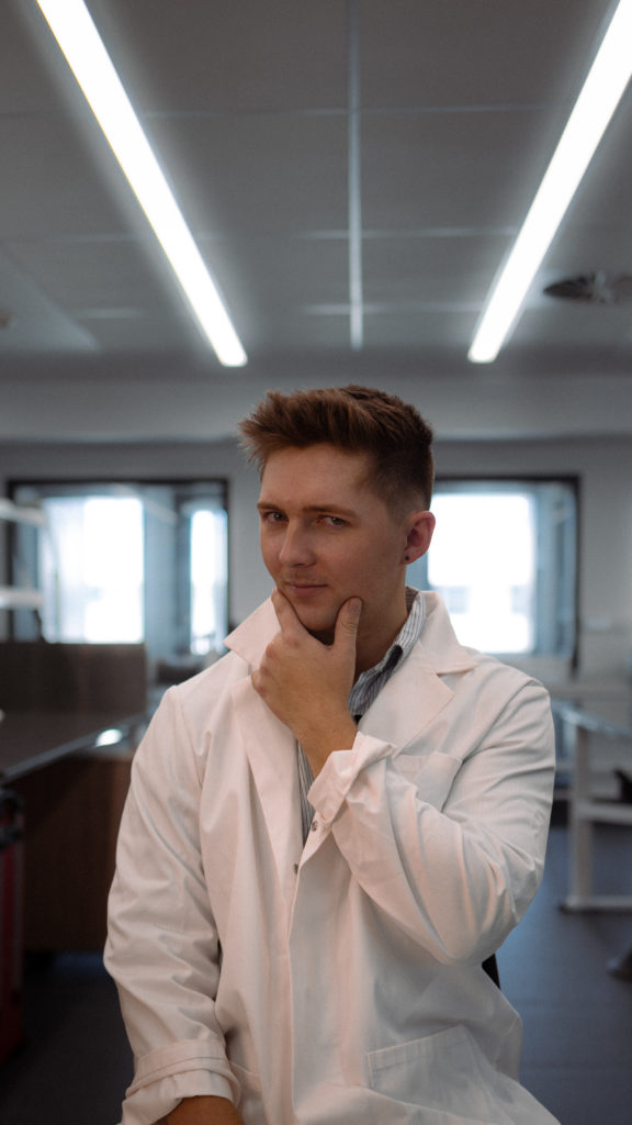 Ethan strikes a pose in his lab coat.