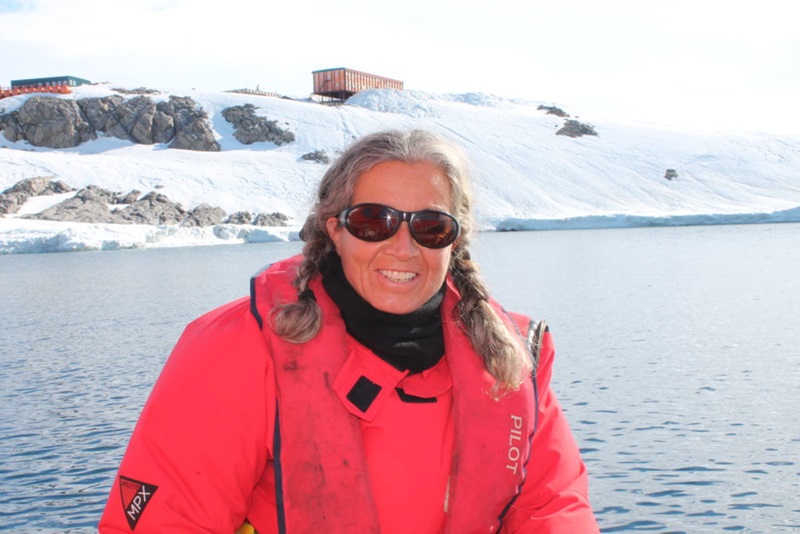 Madeleine Habib has been a ship's captain on the Investigator. Here she stands in front of an Antarctic base.