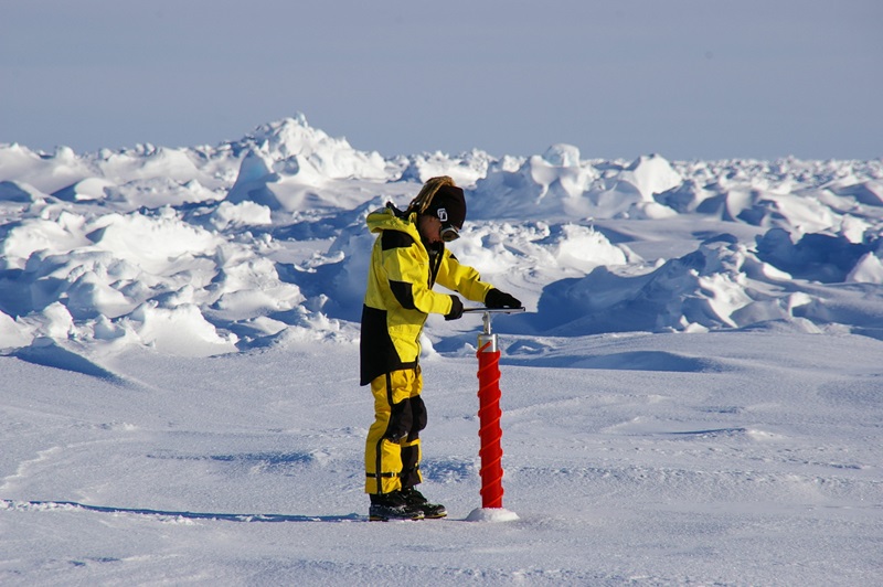 Researcher Jess Melbourne-Thomas taking a sea ice core to measure phytoplankton abundance in East Antarctica.