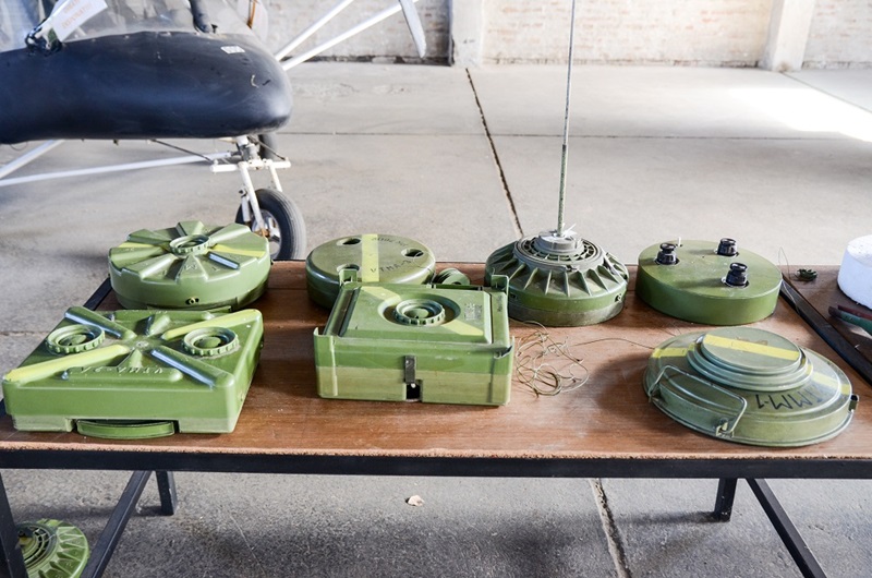 A photo showing a table which on it has a series of different shaped landmines that are all green in colour.