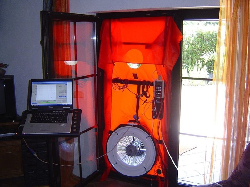 scientific fan placed in doorway with computer logging air movement to help draught proof house