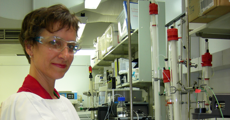 Lesley Pearce stands in a lab wearing protection gear.