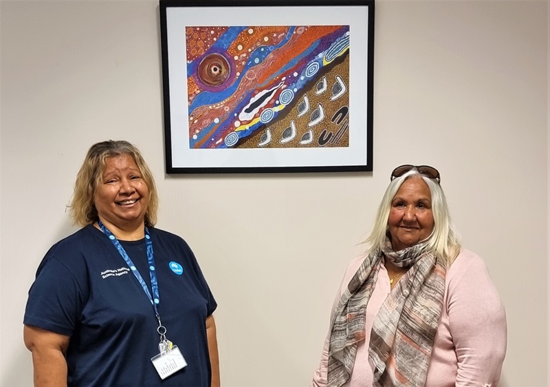 Margaret Whitehurst is photographed in front of her painting with CSIRO's Leonie Boddington.