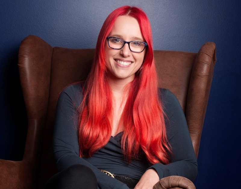 Megan Sebben sitting on a chair and smiling at the camera