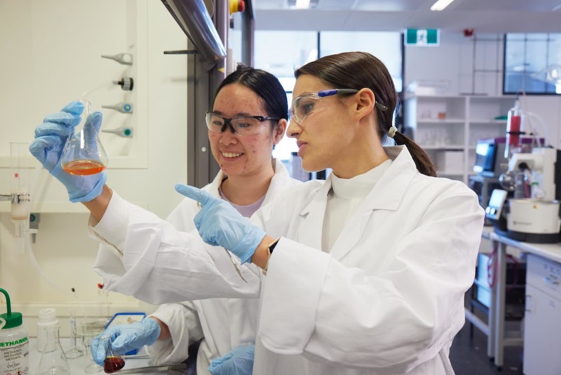 A photo of two psychedelic researchers working in a science labratory.