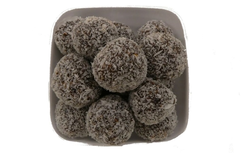 Chocolate protein balls covered in coconut.