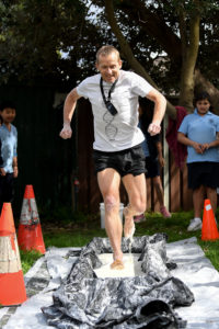 A man appears to run across the surface of a white liquid in a large trough