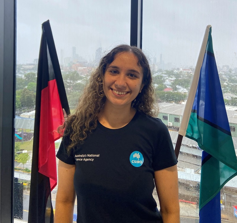 Ziggi Busch standing at her graduation now works on Indigenous Cultural and Intellectual Property