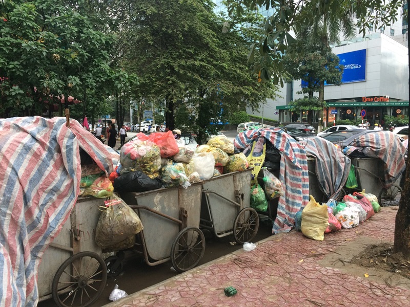 Carts piled high with bags of rubbish